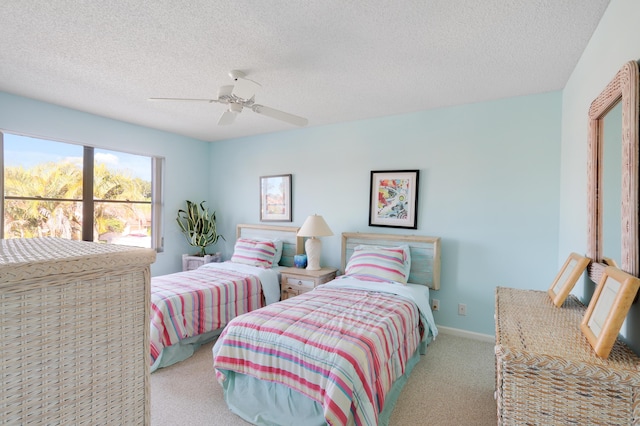 carpeted bedroom with ceiling fan and a textured ceiling