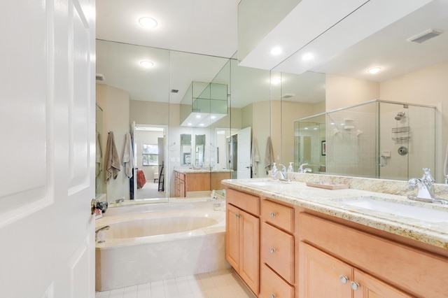 bathroom featuring vanity and independent shower and bath