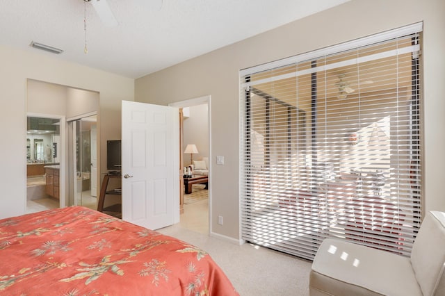 carpeted bedroom featuring a textured ceiling, connected bathroom, and ceiling fan