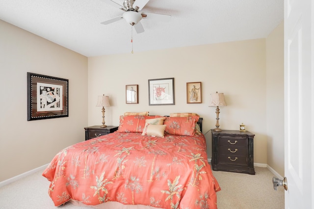 carpeted bedroom featuring ceiling fan and a textured ceiling