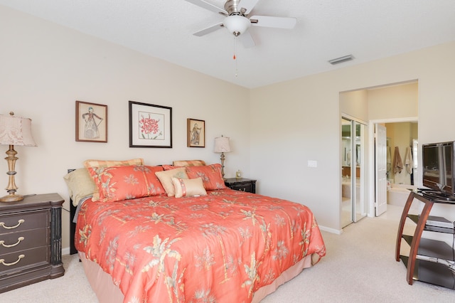 carpeted bedroom featuring ensuite bathroom and ceiling fan