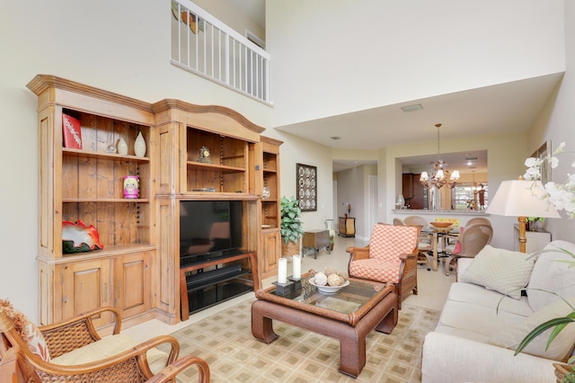 living room featuring a towering ceiling and an inviting chandelier