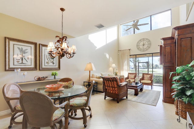 dining area featuring ceiling fan with notable chandelier