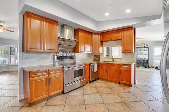 kitchen featuring wall chimney exhaust hood, stainless steel appliances, tasteful backsplash, lofted ceiling, and light tile patterned flooring