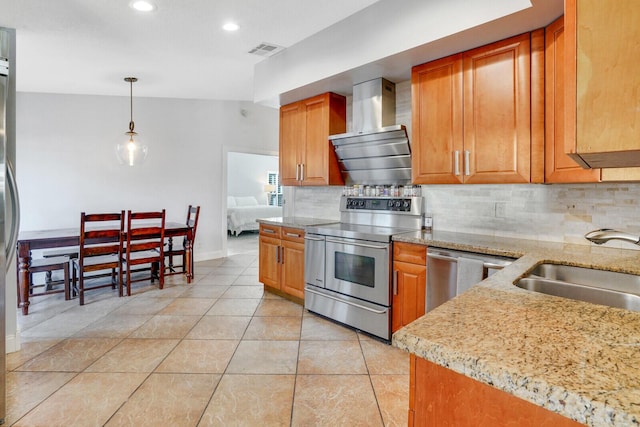 kitchen with decorative backsplash, appliances with stainless steel finishes, wall chimney exhaust hood, and sink