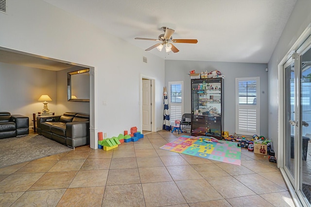 recreation room featuring light tile patterned floors, ceiling fan, and lofted ceiling