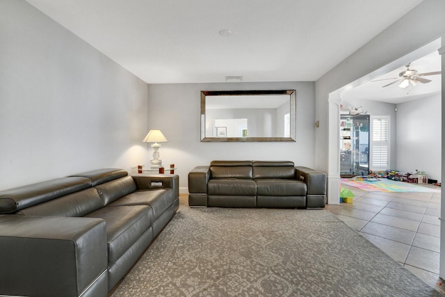 living room featuring tile patterned flooring and ceiling fan