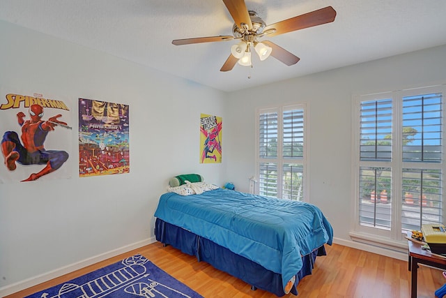 bedroom with hardwood / wood-style floors and ceiling fan