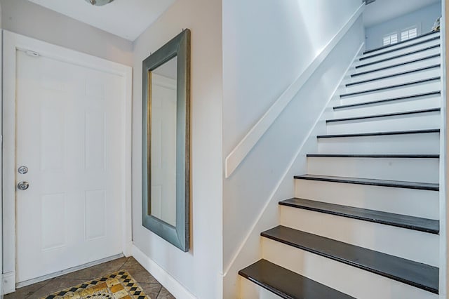 stairway featuring tile patterned flooring