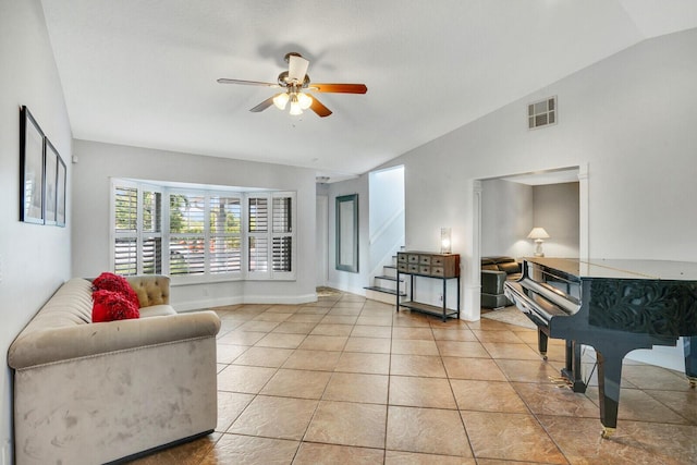 living room with vaulted ceiling, ceiling fan, and light tile patterned flooring