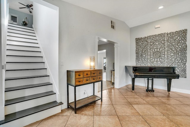 staircase with ornate columns, ceiling fan, tile patterned flooring, and lofted ceiling