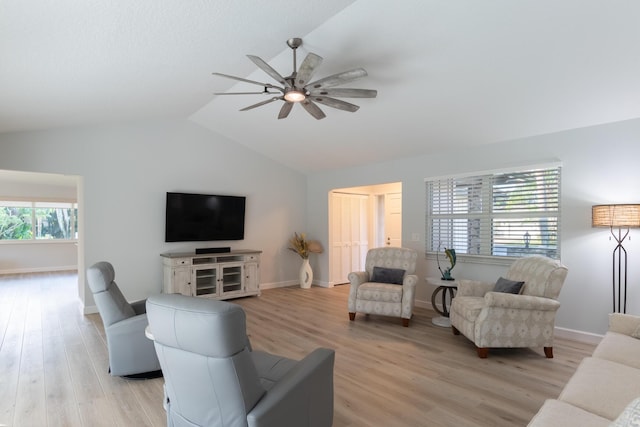 living room featuring ceiling fan, light hardwood / wood-style flooring, and lofted ceiling