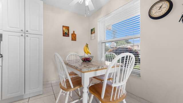 tiled dining room with ceiling fan