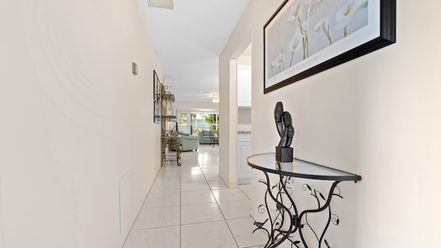 hall featuring light tile patterned floors