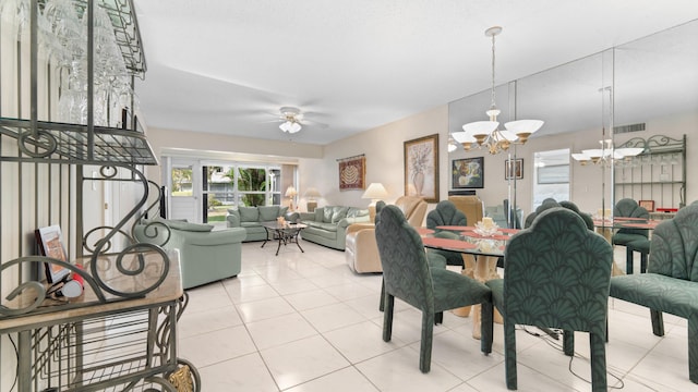 dining area featuring ceiling fan with notable chandelier and light tile patterned flooring