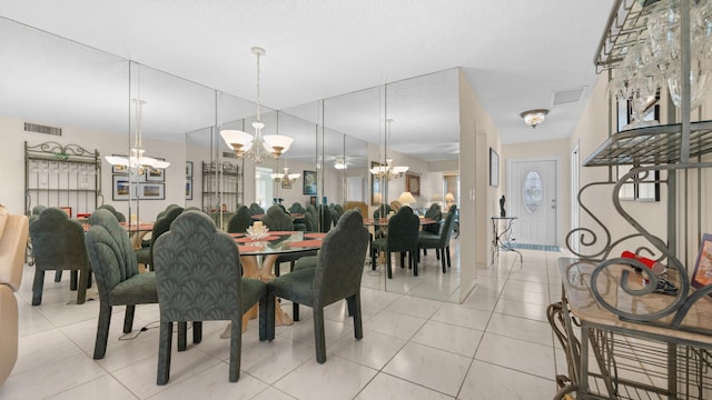 tiled dining area featuring a notable chandelier