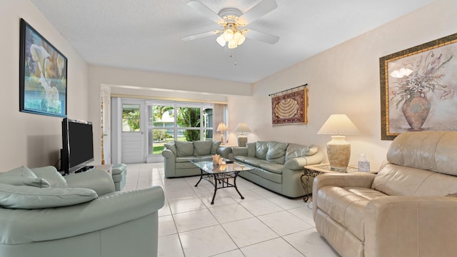 tiled living room featuring ceiling fan and a textured ceiling