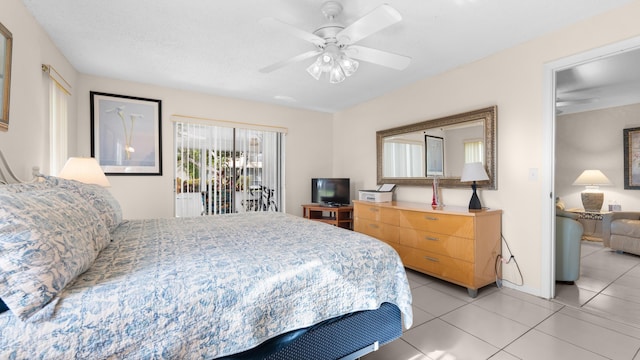 bedroom featuring access to exterior, ceiling fan, and light tile patterned flooring