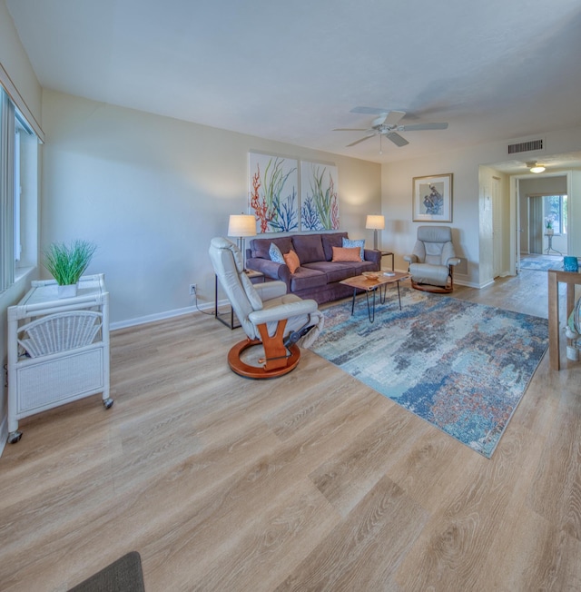 living room featuring light wood-type flooring and ceiling fan