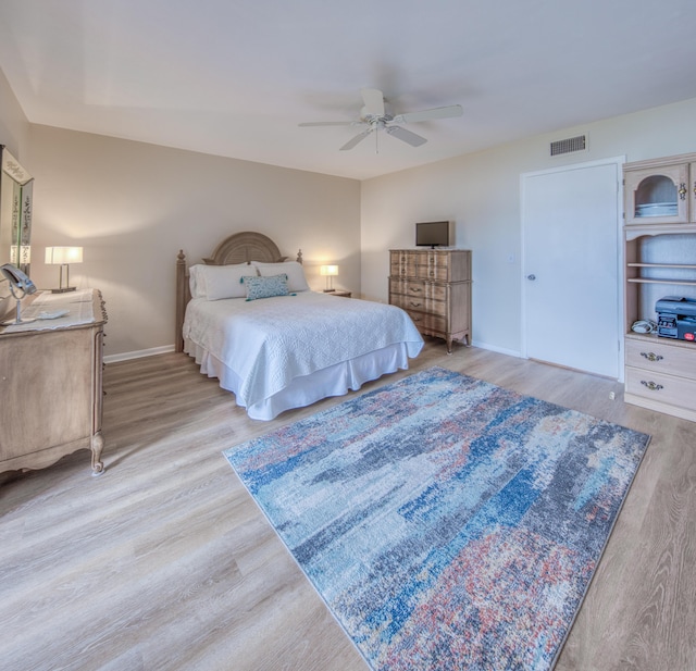 bedroom with ceiling fan and light hardwood / wood-style flooring