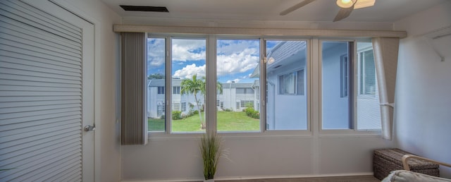 doorway featuring ceiling fan