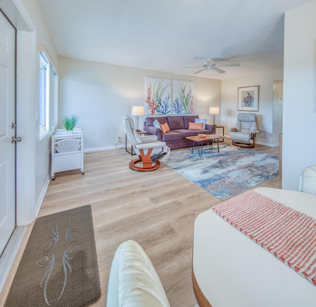 living room with ceiling fan and light hardwood / wood-style floors