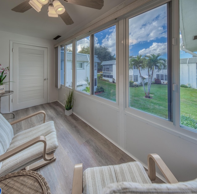 sunroom / solarium featuring ceiling fan and a healthy amount of sunlight