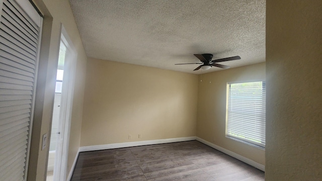 empty room featuring hardwood / wood-style floors, ceiling fan, and a textured ceiling