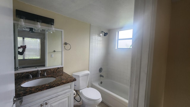 full bathroom with vanity, toilet, and tiled shower / bath combo