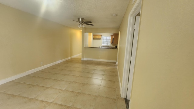 empty room featuring a textured ceiling and ceiling fan