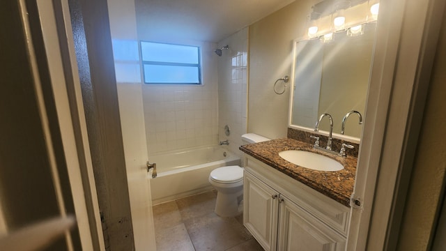 full bathroom with tile patterned floors, vanity, tiled shower / bath, and toilet