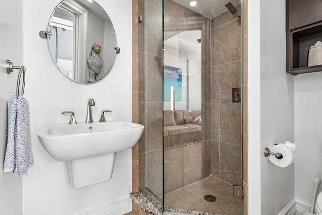 bathroom with an enclosed shower and sink