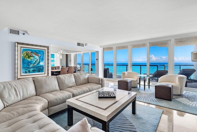 tiled living room with expansive windows and a water view