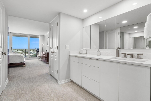 2727 S Ocean Blvd Unit 701, Highland Beach, FL 33487 - bathroom with ensuite bath, carpet floors, baseboards, floor to ceiling windows, and vanity