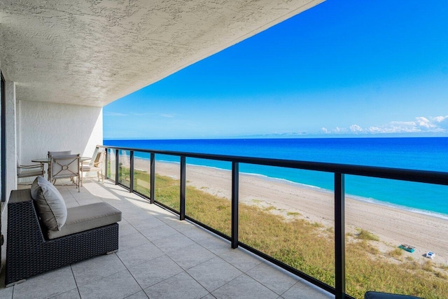 balcony with a beach view and a water view