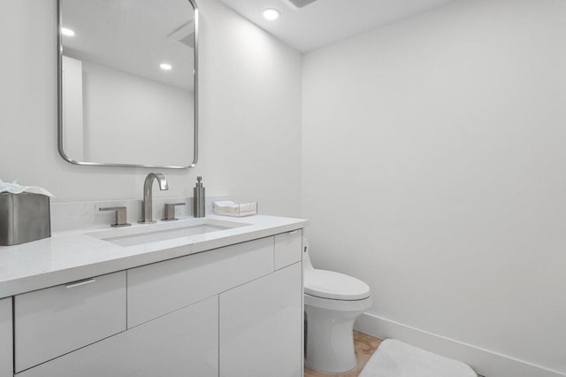 bathroom featuring toilet and vanity