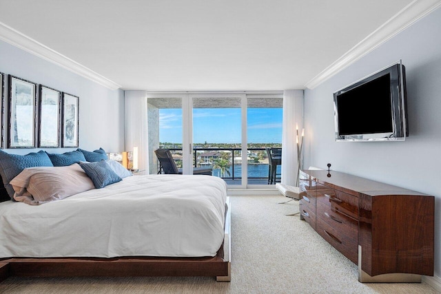 bedroom with ornamental molding, a wall of windows, and light carpet