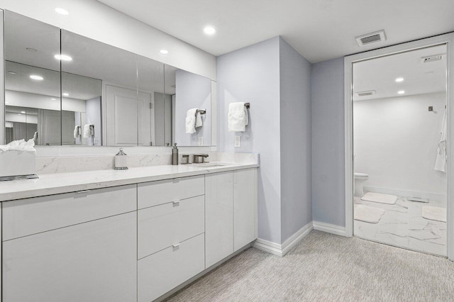 bathroom with vanity and toilet