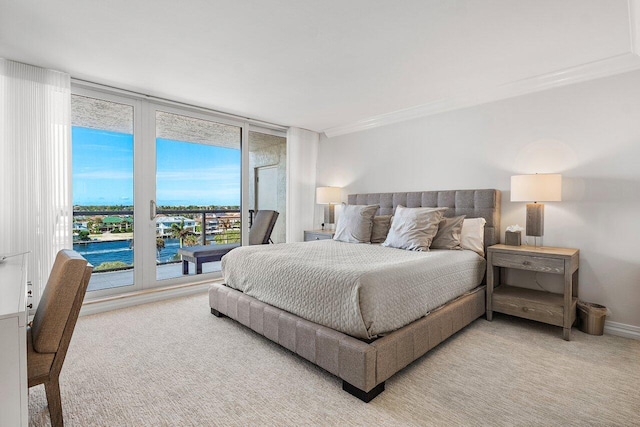 bedroom with ornamental molding and carpet flooring