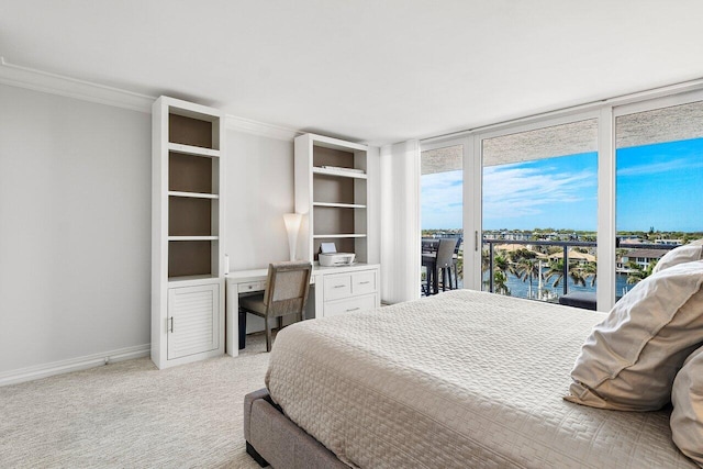 carpeted bedroom featuring access to outside, a wall of windows, crown molding, and a water view