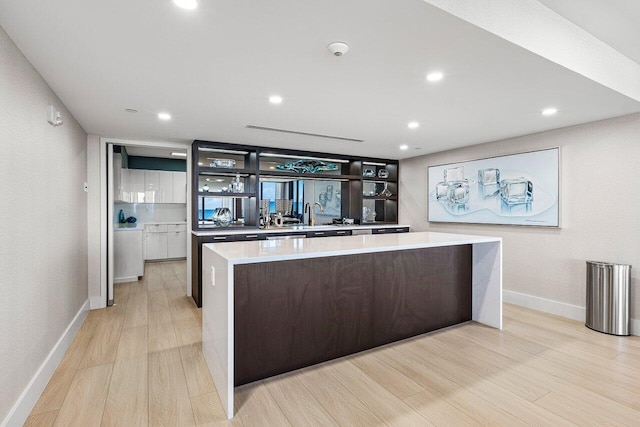 kitchen with light wood-type flooring and a spacious island