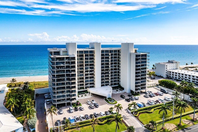 exterior space featuring a beach view and a water view