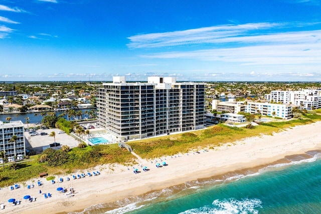 birds eye view of property with a beach view and a water view