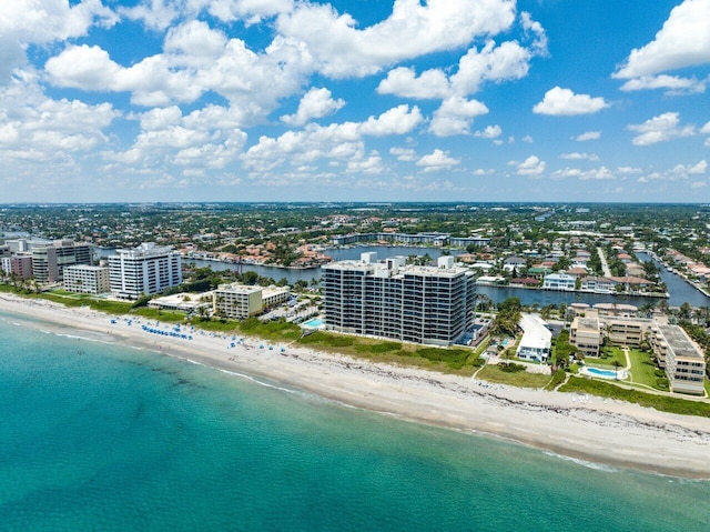 birds eye view of property with a beach view and a water view