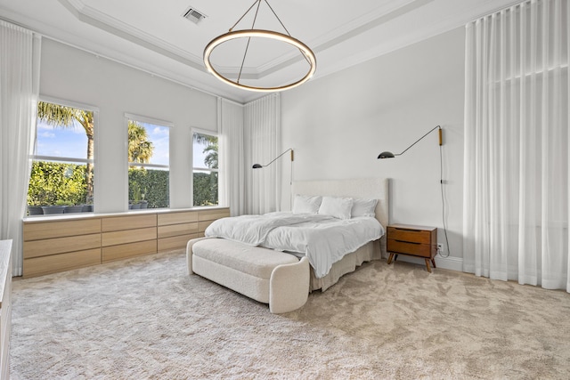 bedroom with carpet flooring, a raised ceiling, and ornamental molding