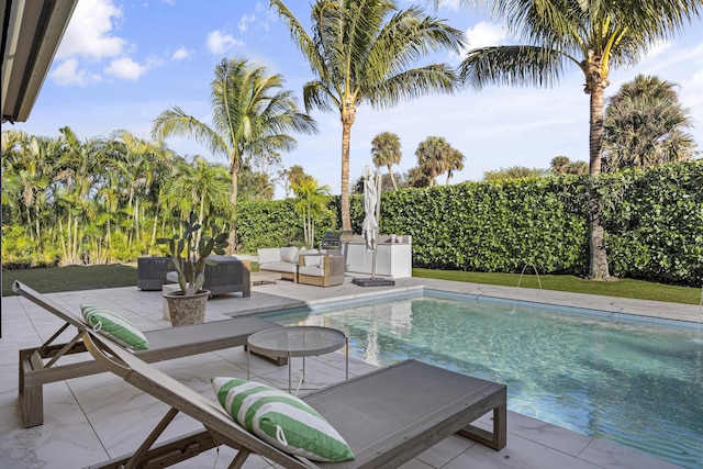 view of pool featuring an outdoor living space and a patio