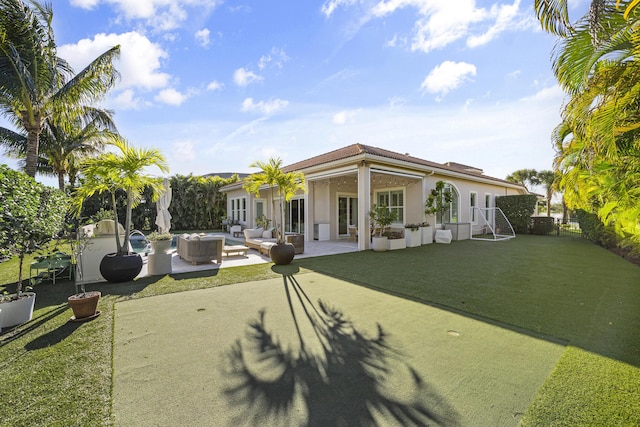 back of house with a lawn, a patio area, and an outdoor living space