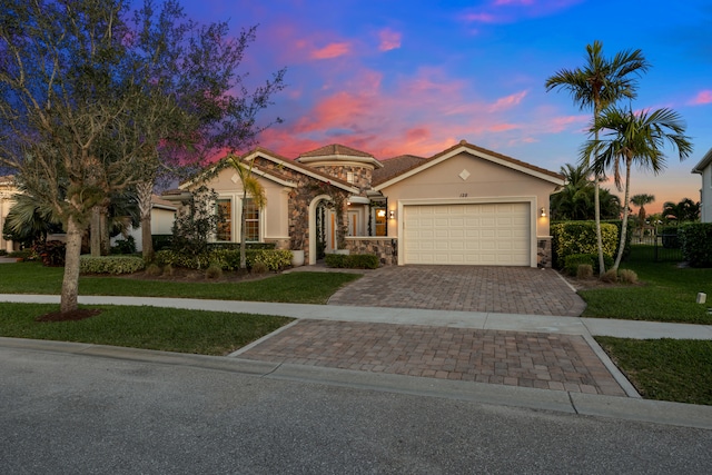 view of front of property with a lawn and a garage