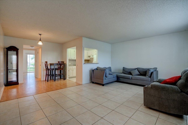 living room featuring a textured ceiling and light hardwood / wood-style flooring