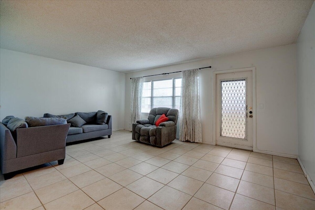 tiled living room featuring a textured ceiling